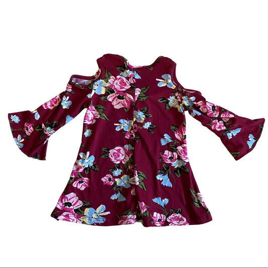 A long-sleeve cold-shoulder top in deep burgundy with a vibrant pink, blue, and green floral print, displayed flat against a white background.