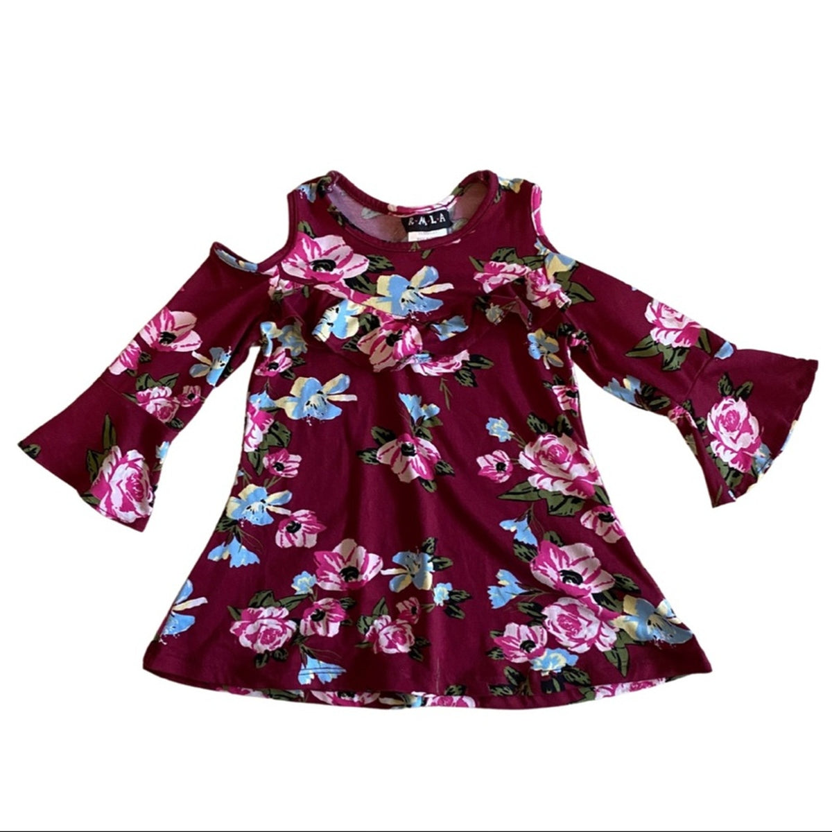 A girls' cold-shoulder top in deep burgundy with a vibrant floral print featuring pink roses, blue butterflies, and green leaves. 