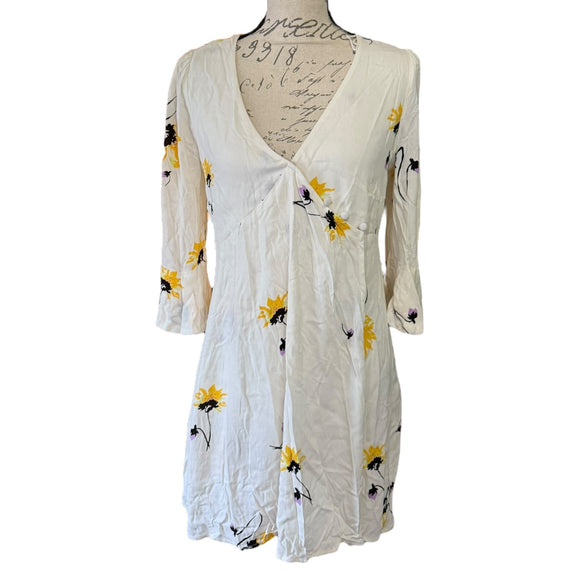 Front of off White dress with floral patterns on a white background