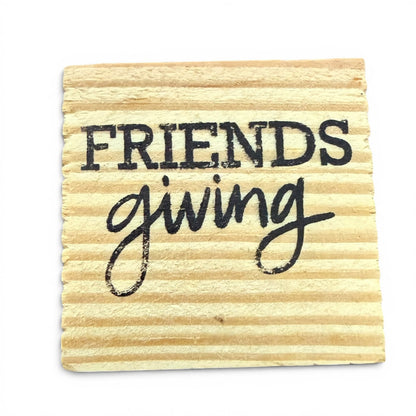 Wooden coaster with 'Friendsgiving' text on a white background