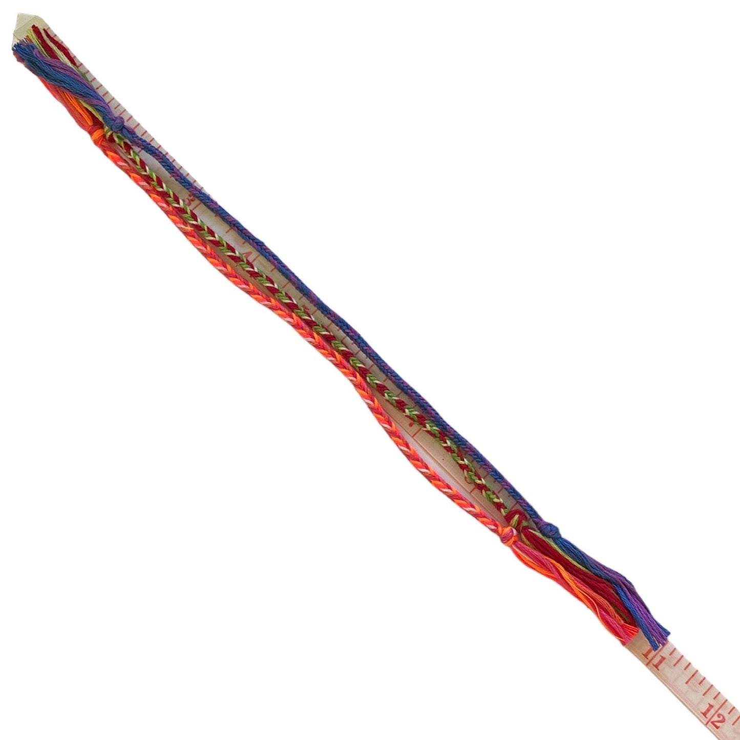 3 Colorful braided stick with a ruler on a white background