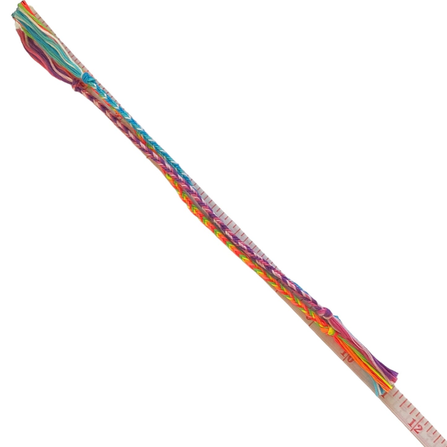 Colorful braided bracelets with a measuring tape on a white background