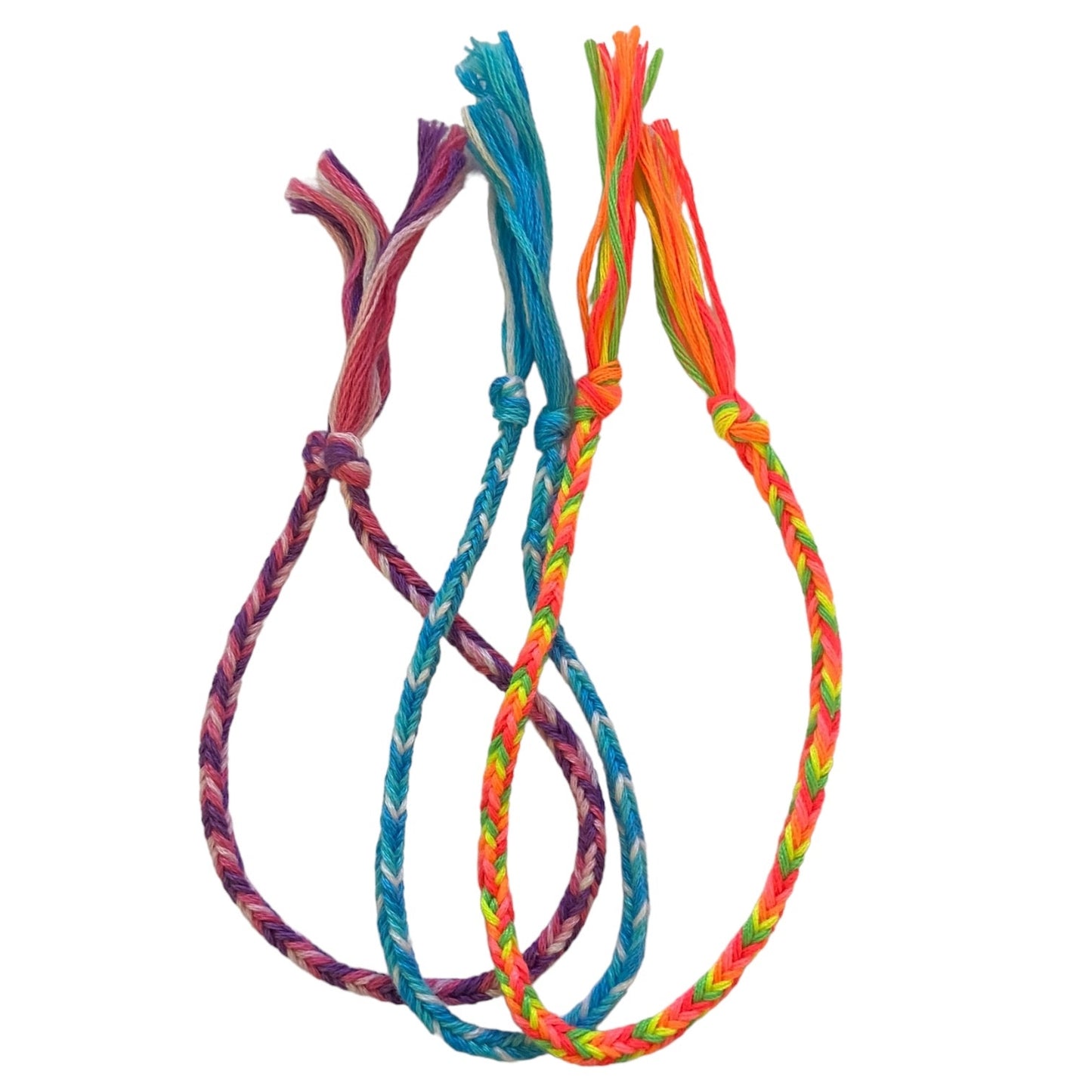 Three colorful braided bracelets on a white background