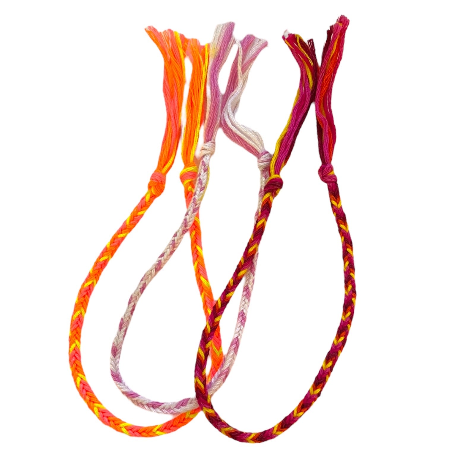 3 braided bracelets with colorful patterns on a white background