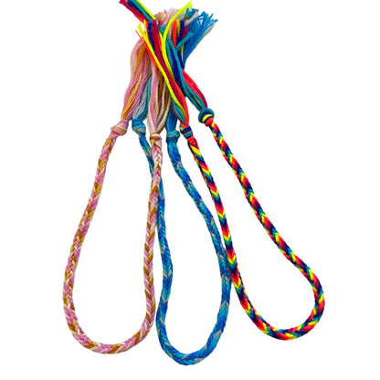 Colorful braided bracelets on a white background