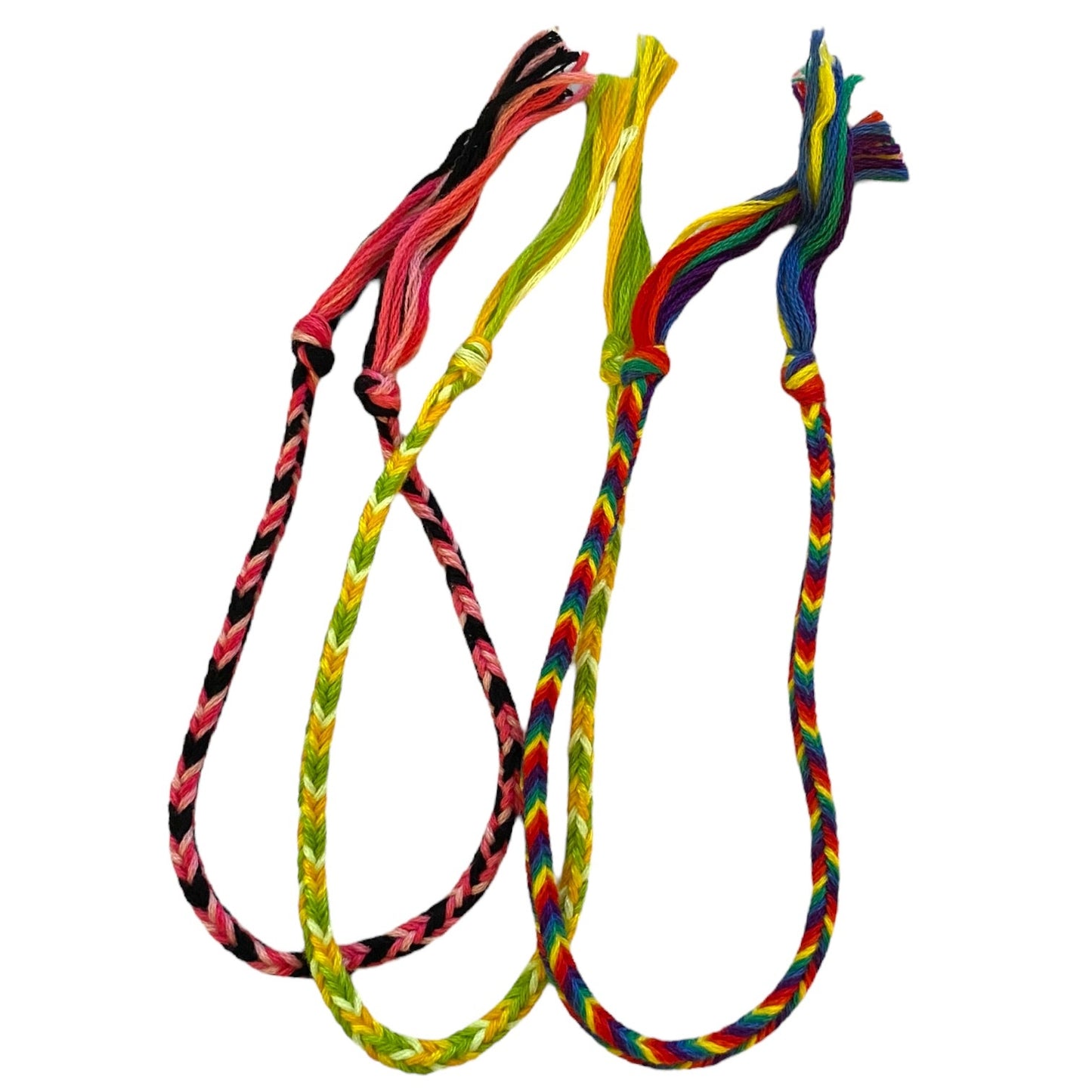Three multicolor handmade friendship bracelets set against a white background