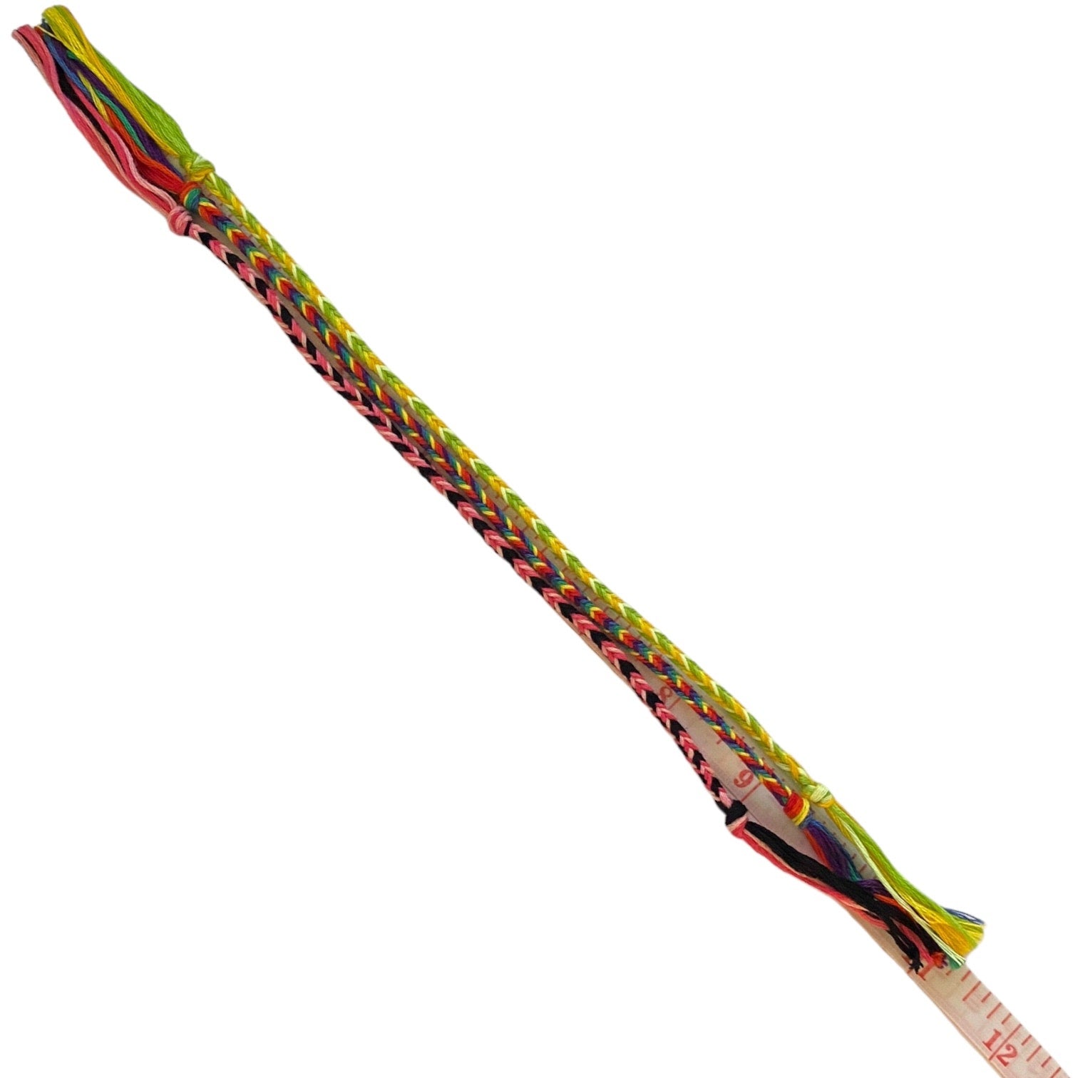 3 multicolor friendship bracelets. A small measuring tape is visible near one end.