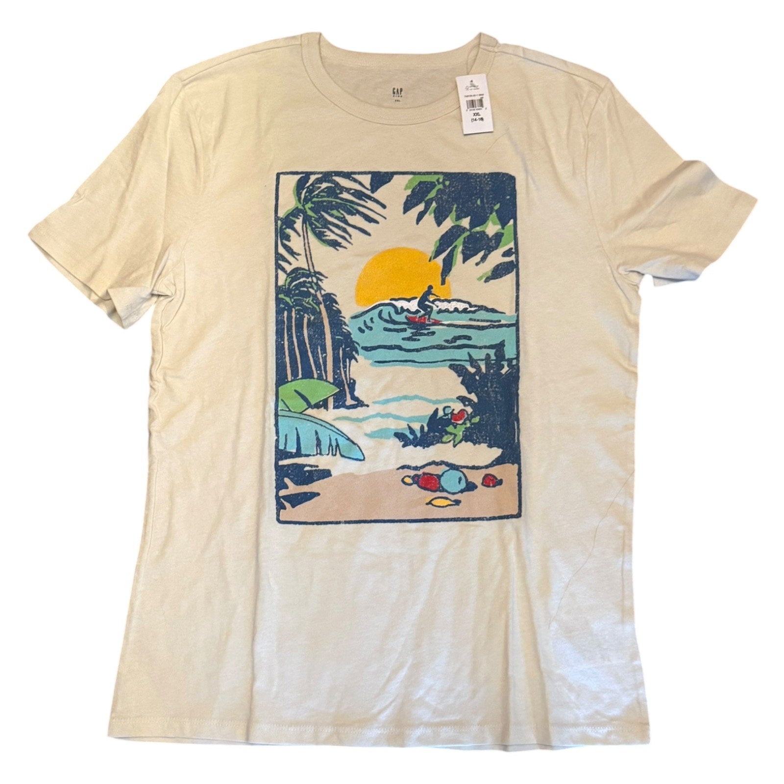 A short-sleeve t-shirt with a vintage-style tropical beach graphic on the front, featuring a yellow sun, palm trees, and a surfer, shown flat against a white background.