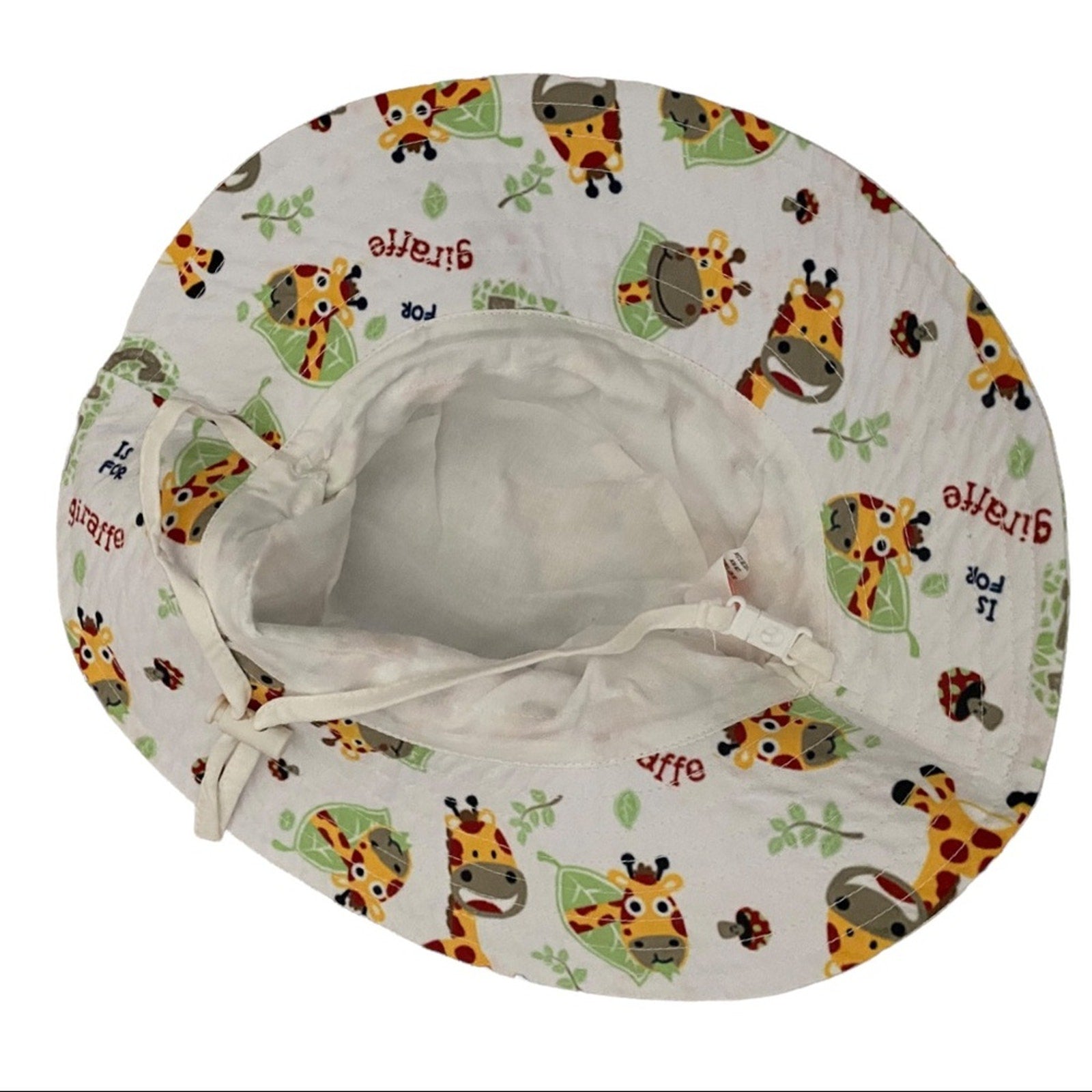Bottom side of bucket hat with giraffe pattern on a white background