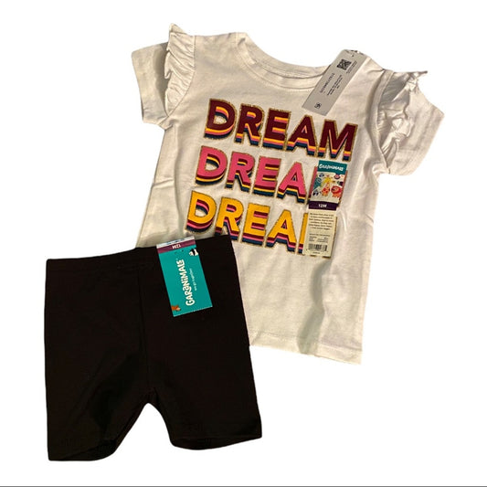 Children's outfit with 'Dream Dream Dream' t-shirt and black shorts on a white background