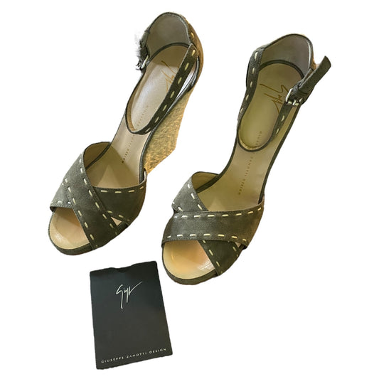 Pair of green high-heeled sandals with a black card on a white background