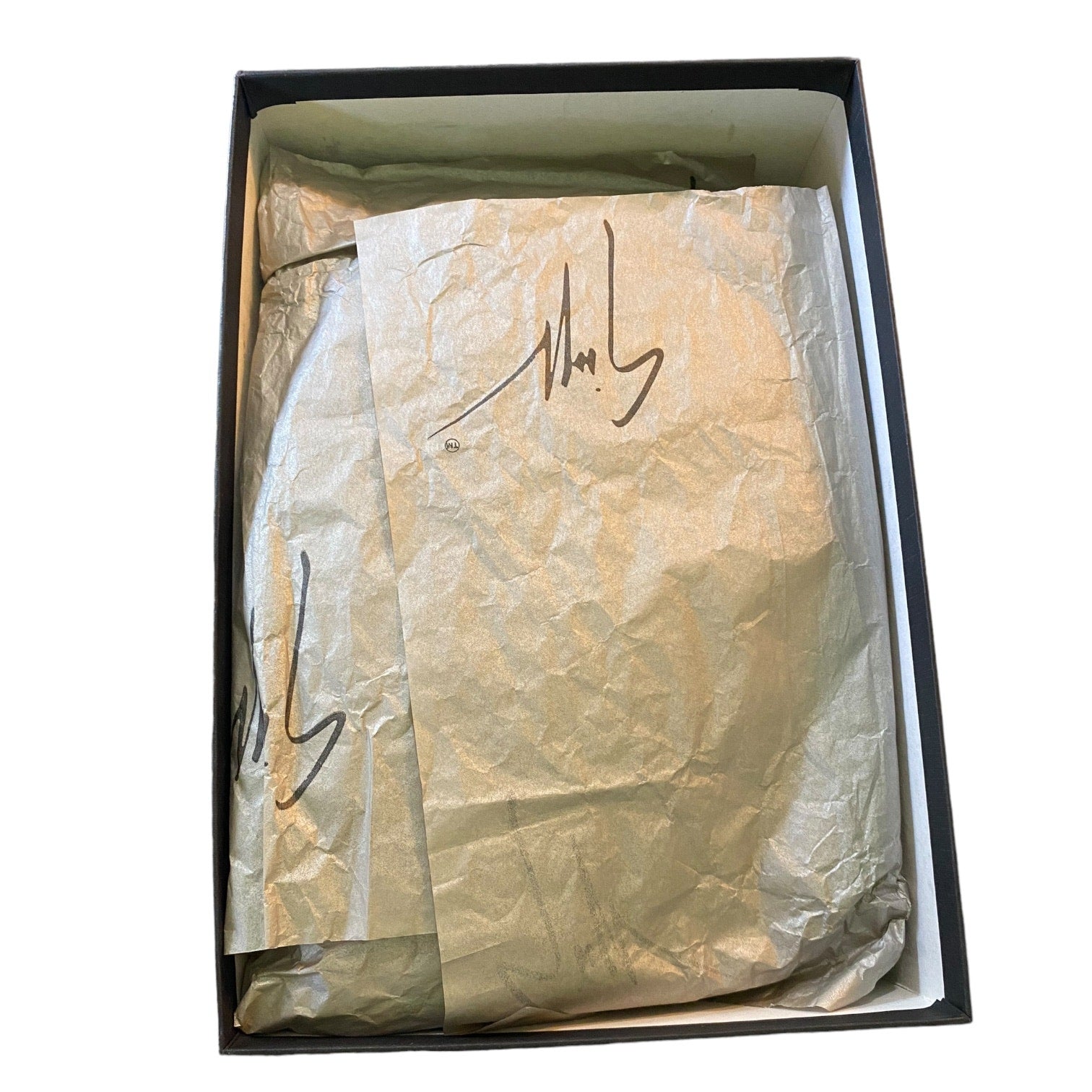 Box with tissue paper inside, featuring a signature.