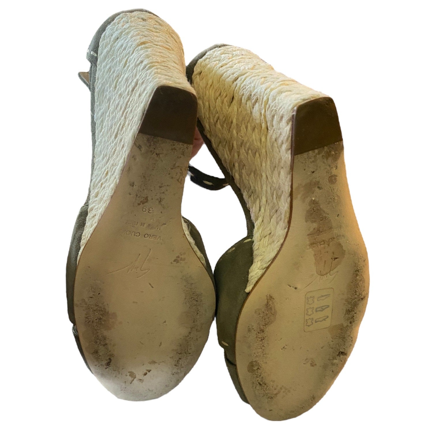 Pair of shoes showing the bottoms on a white background