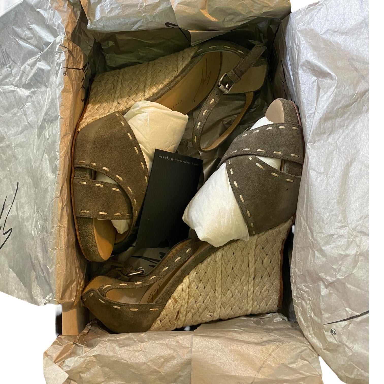 Green sandals and in a box inside with tissue paper