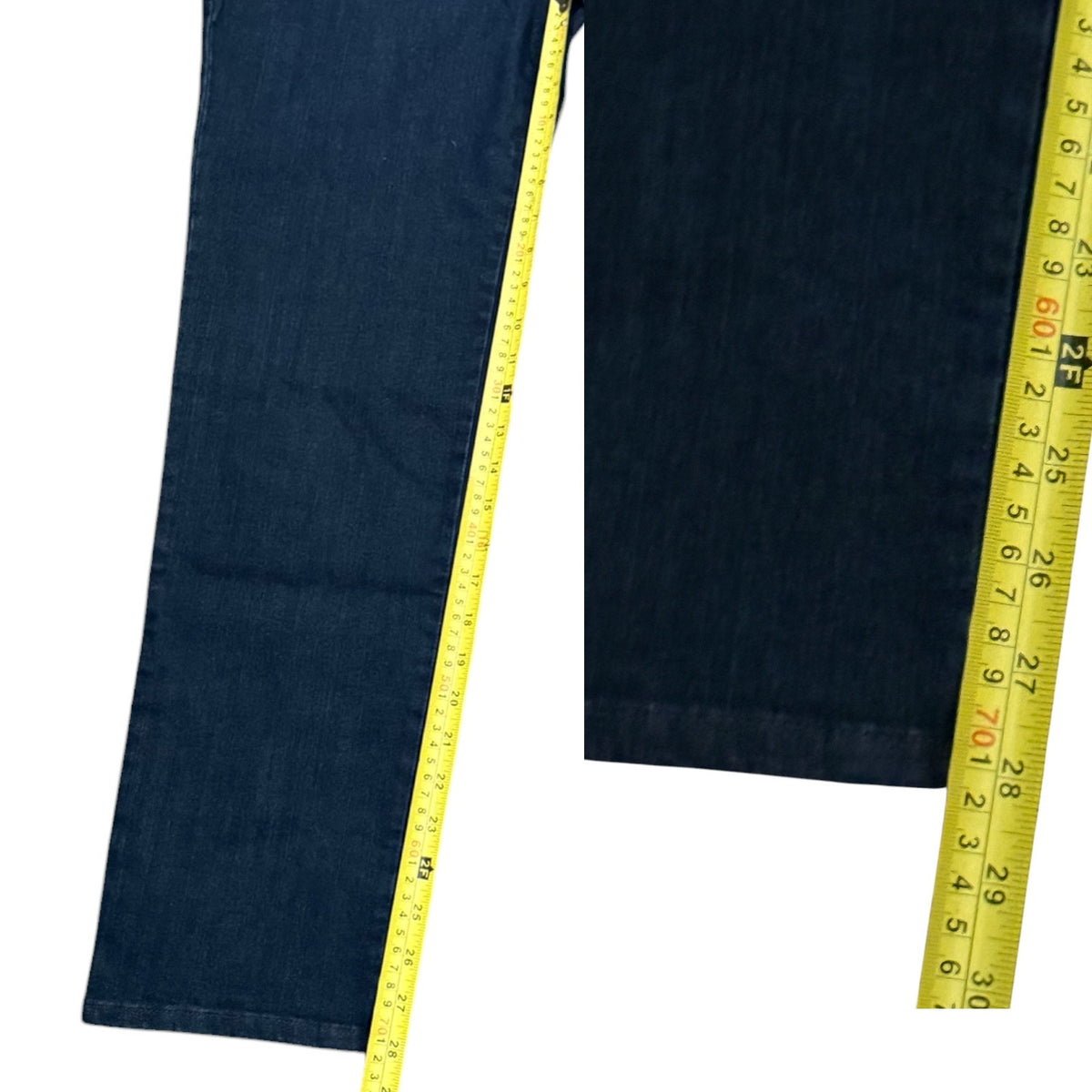 Dark blue denim jeans shown with yellow measuring tapes along both legs to indicate inseam.