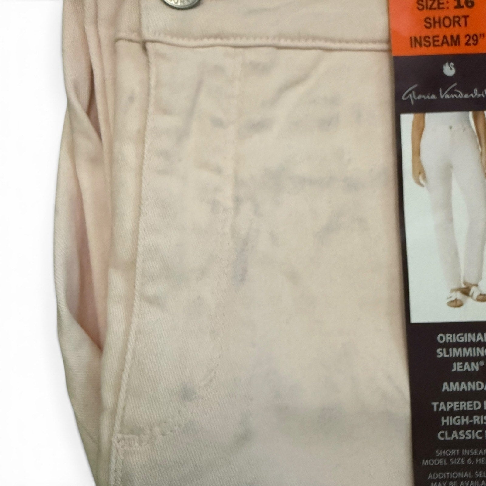 Pink jeans with blue issues and Gloria Vanderbilt tag on a white background