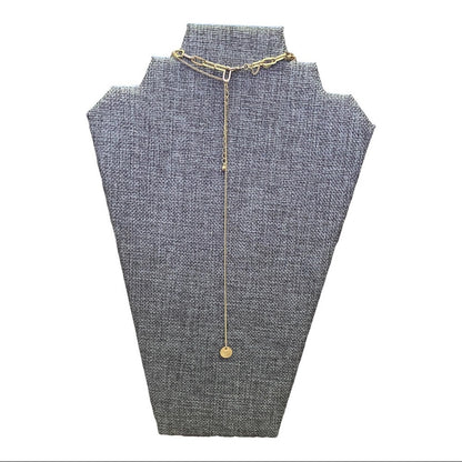 Gold necklace on a gray mannequin bust with a white background