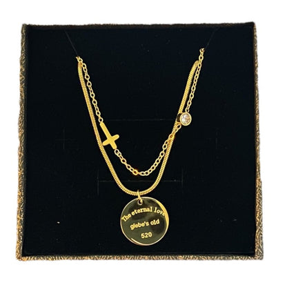 Gold tone necklace with a pendant on a black display box