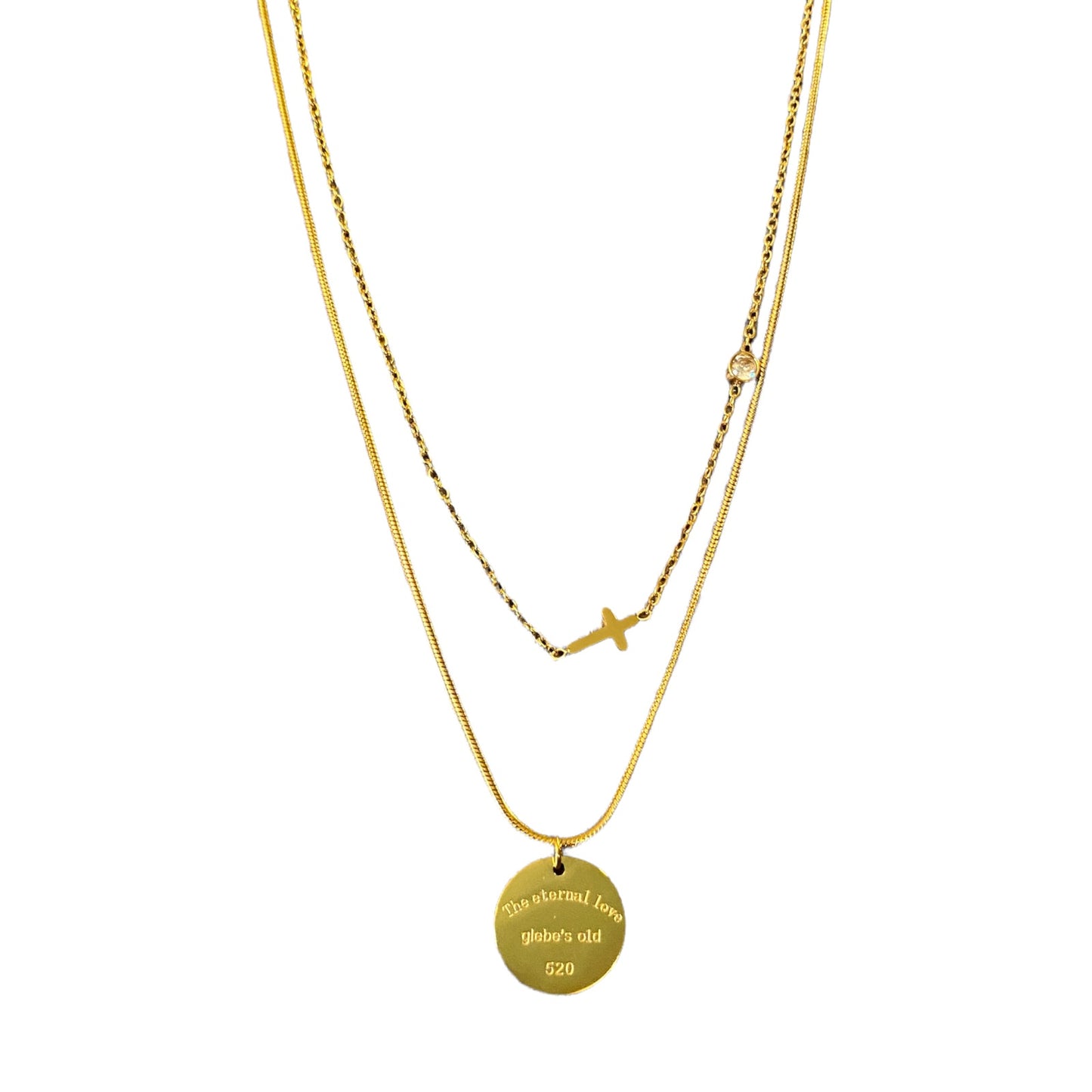 Layered gold tone necklaces with pendants on a white background