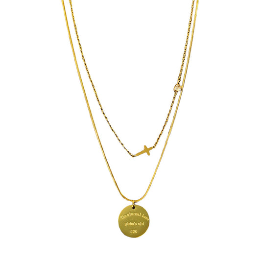 Layered gold tone necklaces with pendants on a white background