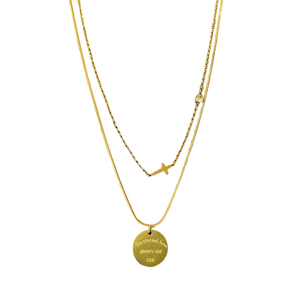 Layered gold tone necklaces with pendants on a white background
