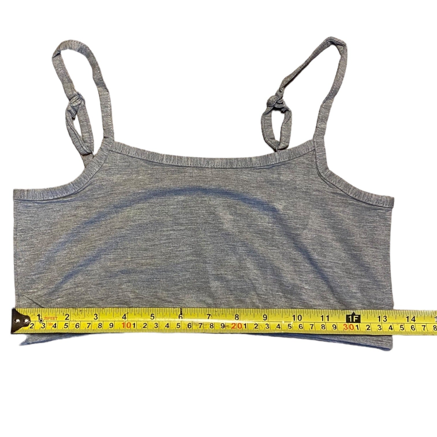 Gray tank top with measuring tape on a white background