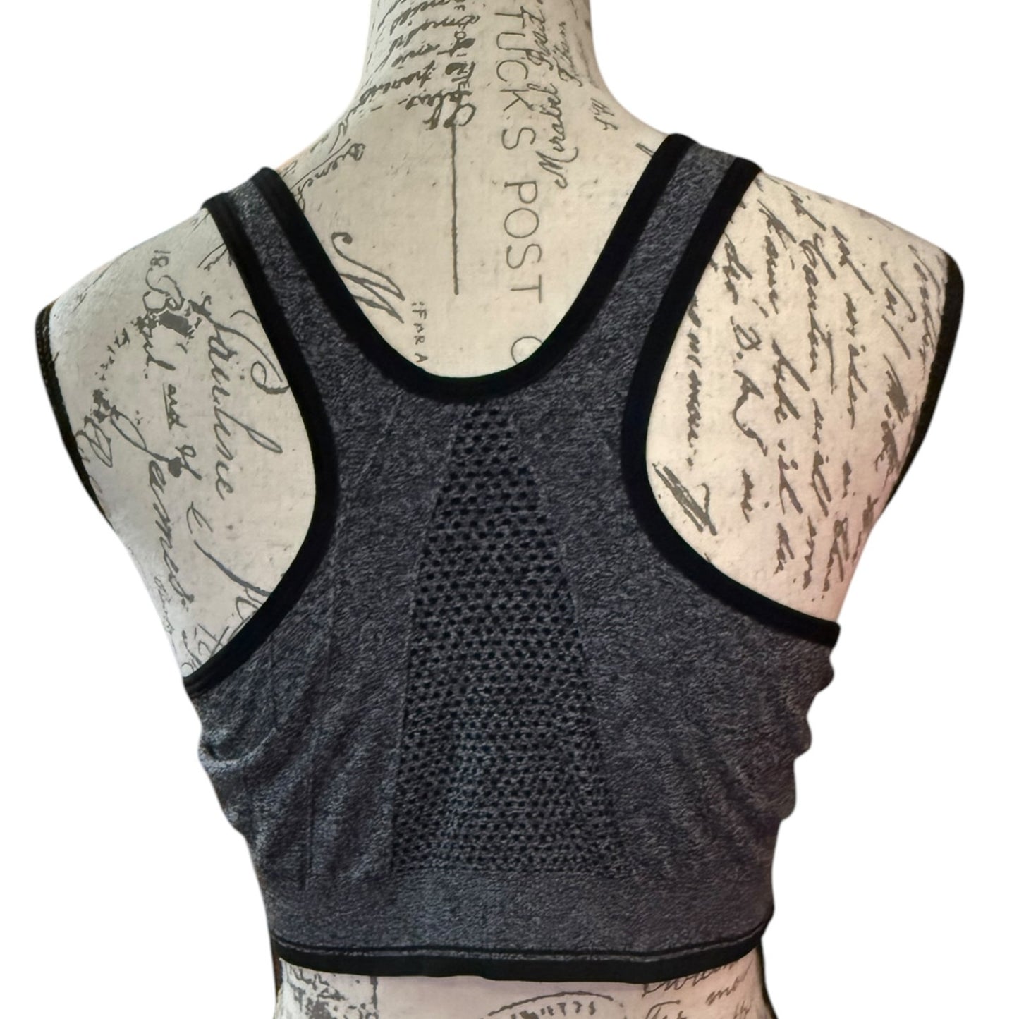 Back of Gray sports bra on a mannequin with a white background
