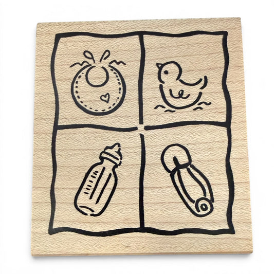 Wooden baby-themed stamp with illustrations of a bottle, diaper, and other items on a white background.