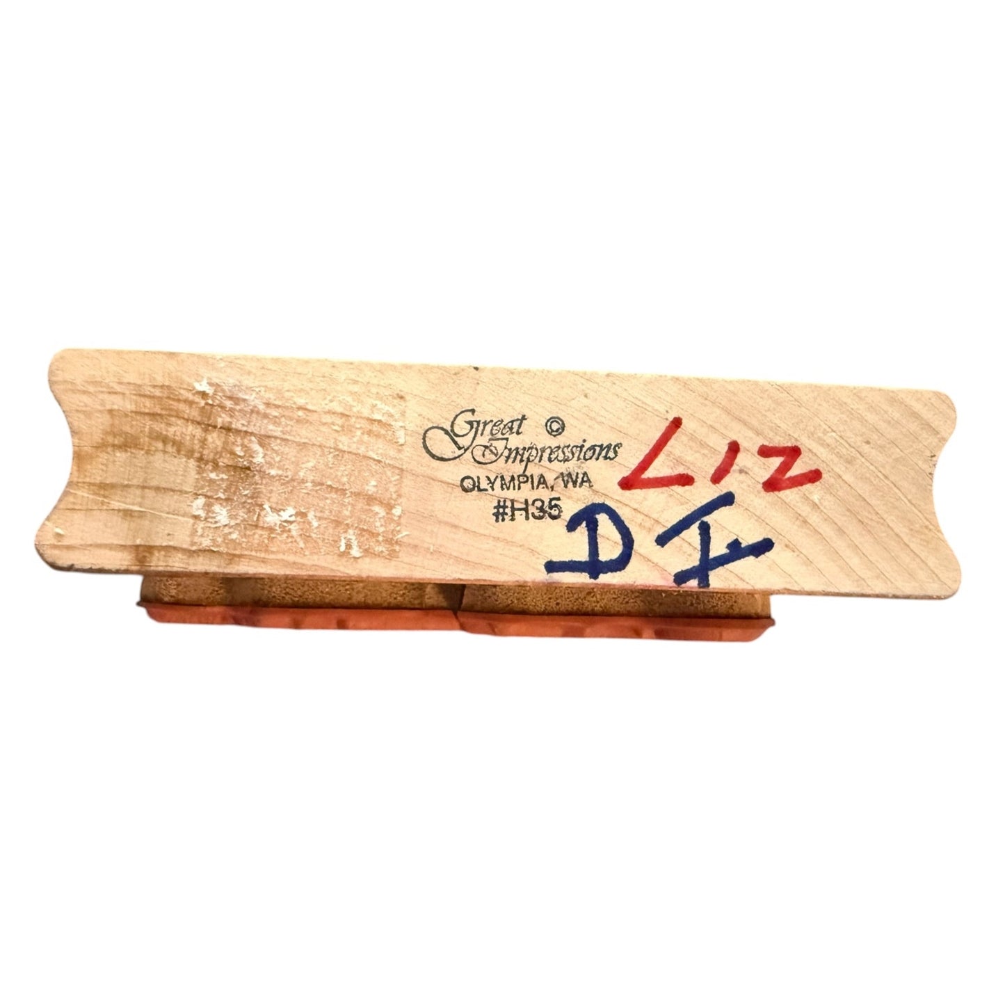 Wooden block with branding and text on a white background