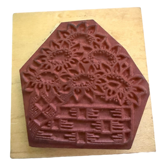 Decorative stamp with floral design on a wooden block
