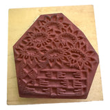 Decorative stamp with floral design on a wooden block