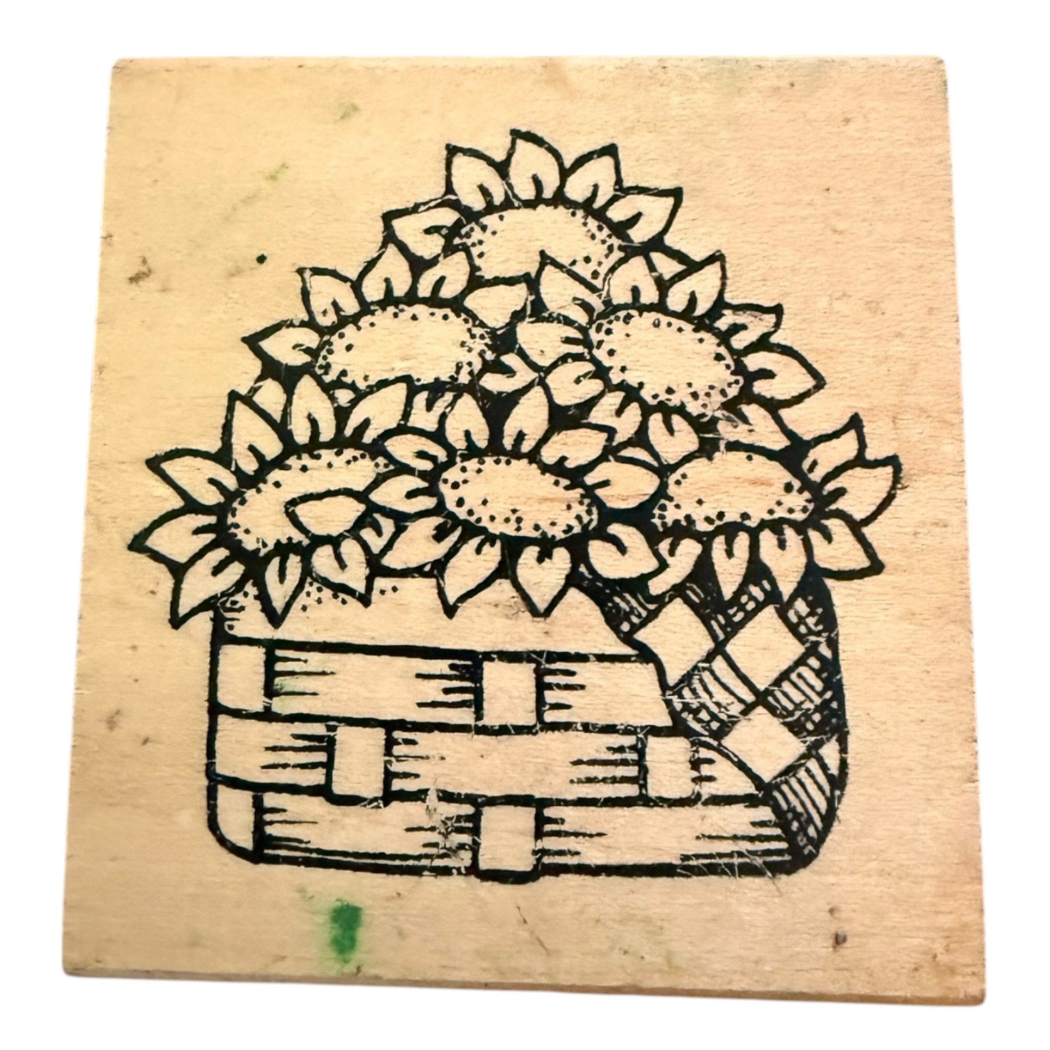 Rubber stamp with a design of sunflowers in a basket on a wooden block.