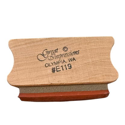 Wooden stamp with 'Great Impressions' branding on a white background