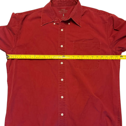 Red shirt with a yellow measuring tape around it on a white background