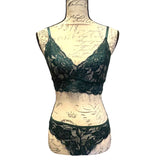 Green lace lingerie set on a mannequin with a vintage-style background
