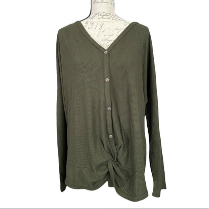 Front of green shirt on a mannequin against a white background