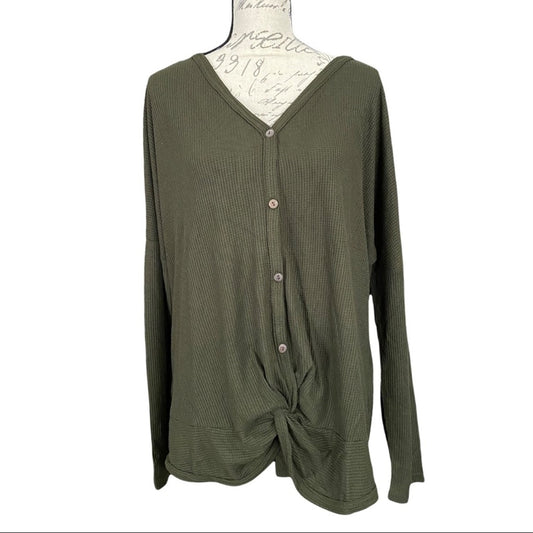 Front of green shirt on a mannequin against a white background