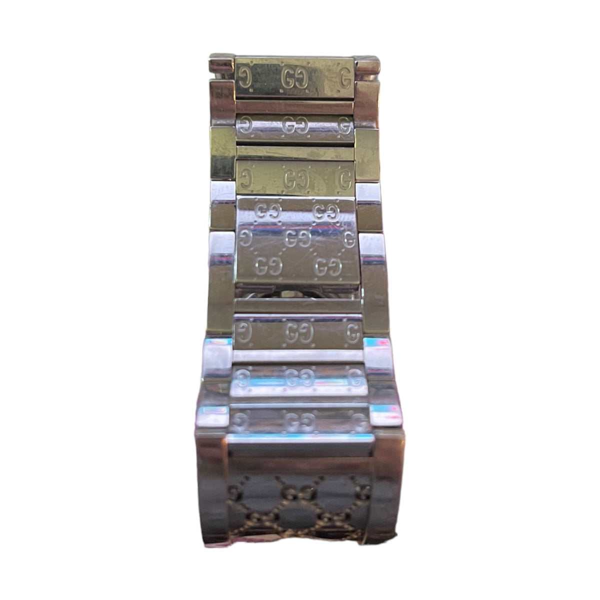 A close-up of a metal watch band with a silver finish, featuring a polished silver-toned center section and a rose gold-toned outer section with engraved 'G' logos.