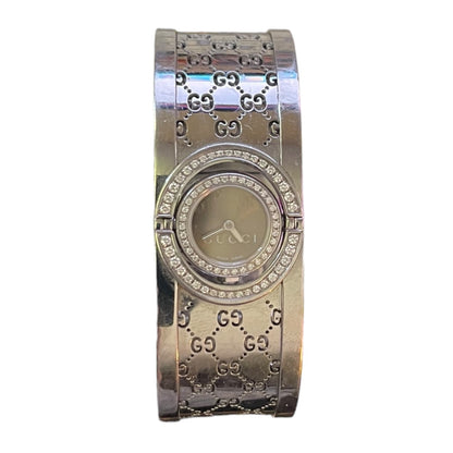 Silver Gucci watch with diamond-studded face on a white background