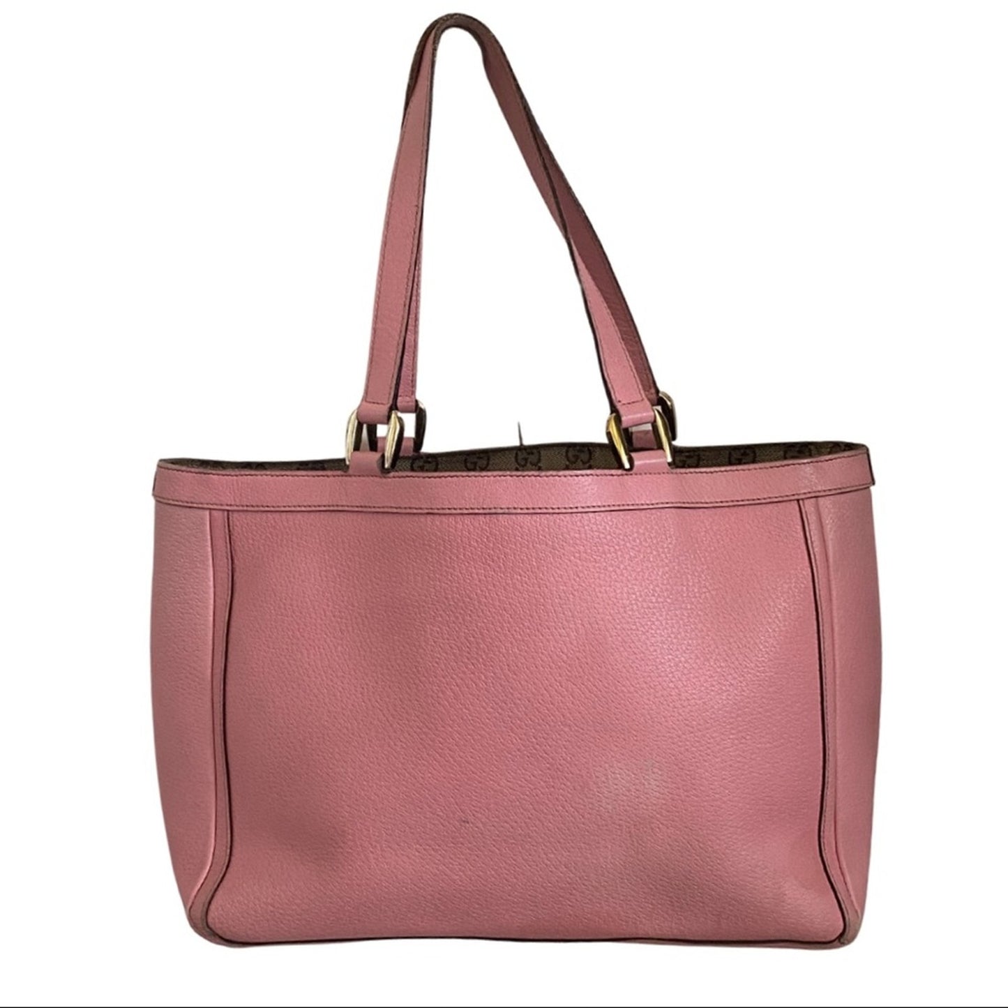Back of Pink handbag with gold accents on a white background