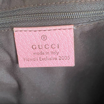 Pink Gucci label on a dark fabric background