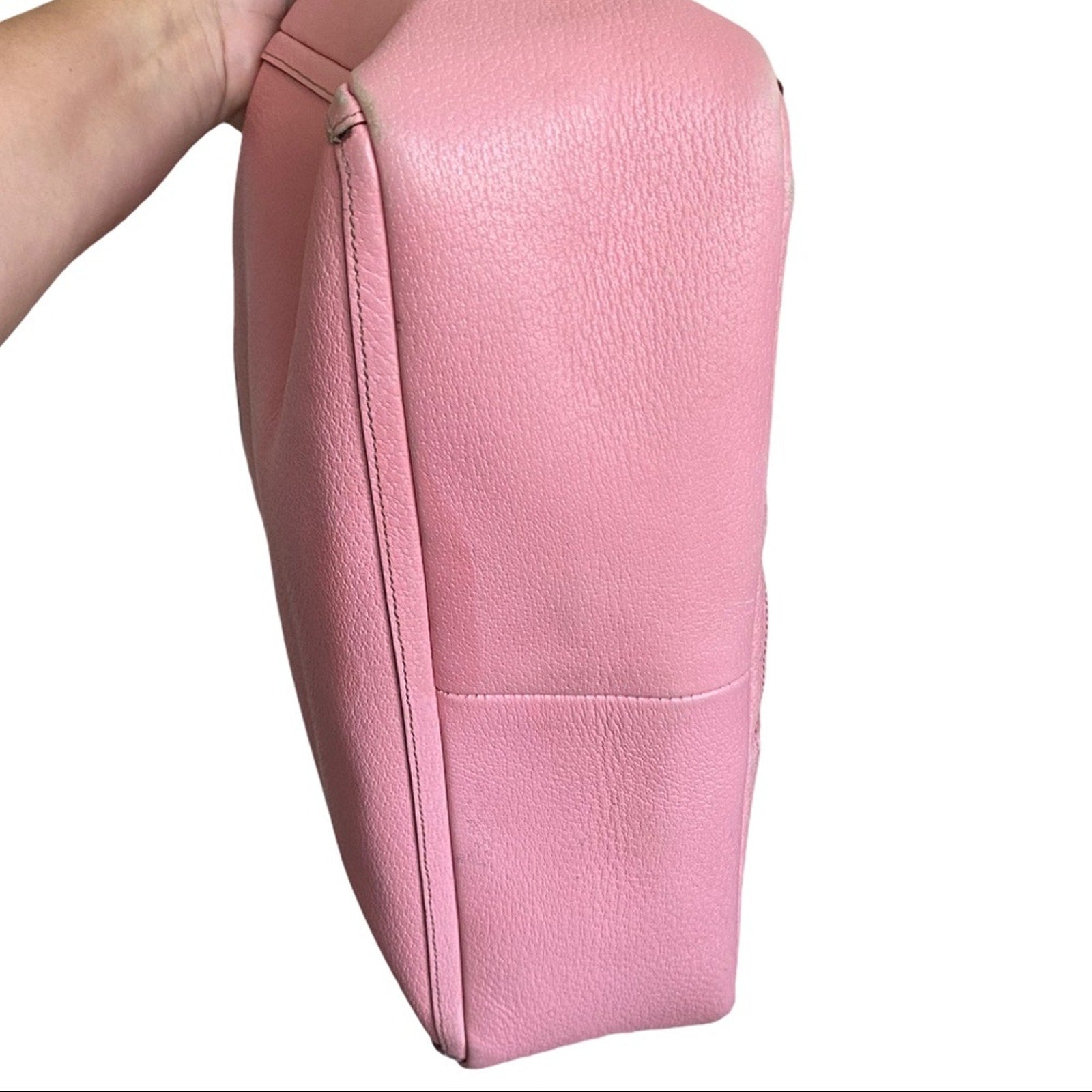 Bottom of pink leather purse on a white background