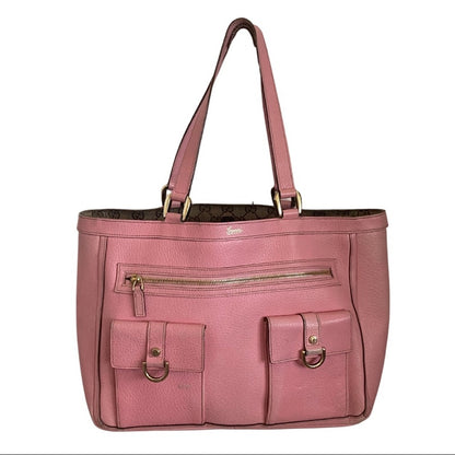 Front of Pink handbag with gold zippers and hardware on a white background