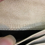 Close-up of serial number on beige surface with embossed text 