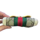 Wallet with green and red stripes held by a hand on a white background