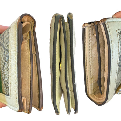 Close-up of sides/edges of a leather wallet with visible stitching and interior details on a white background