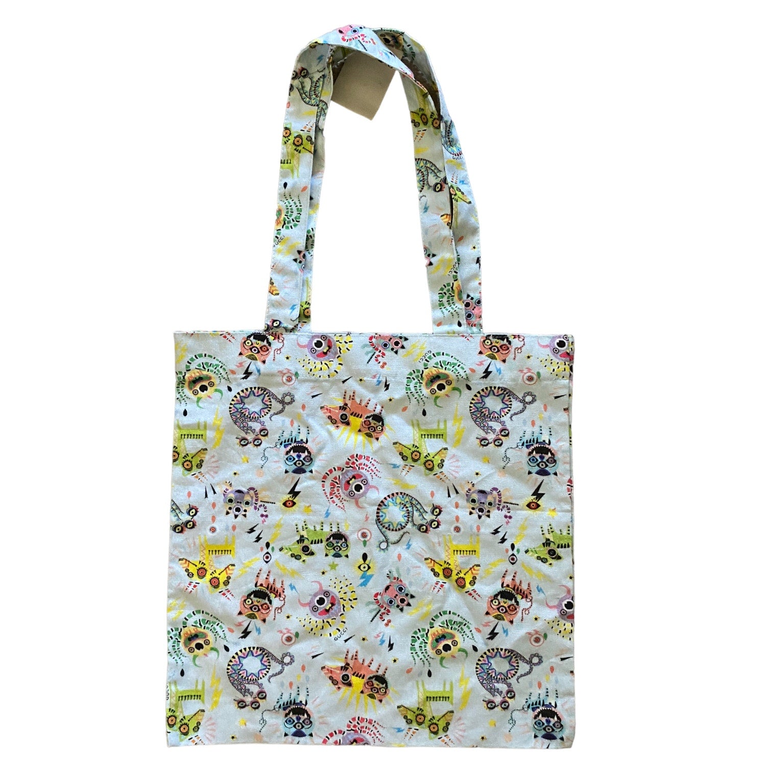 Tote bag with colorful monster pattern on a white background