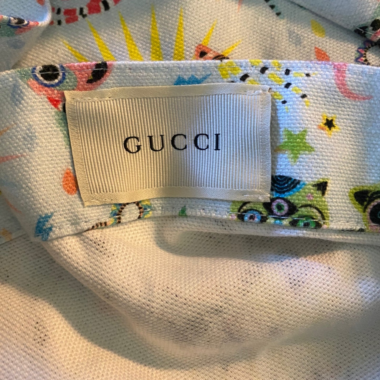 Gucci label with colorful pattern on a textured surface
