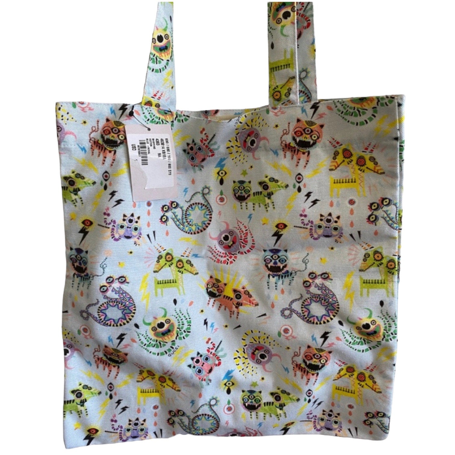 Tote bag with colorful monster pattern on a white background