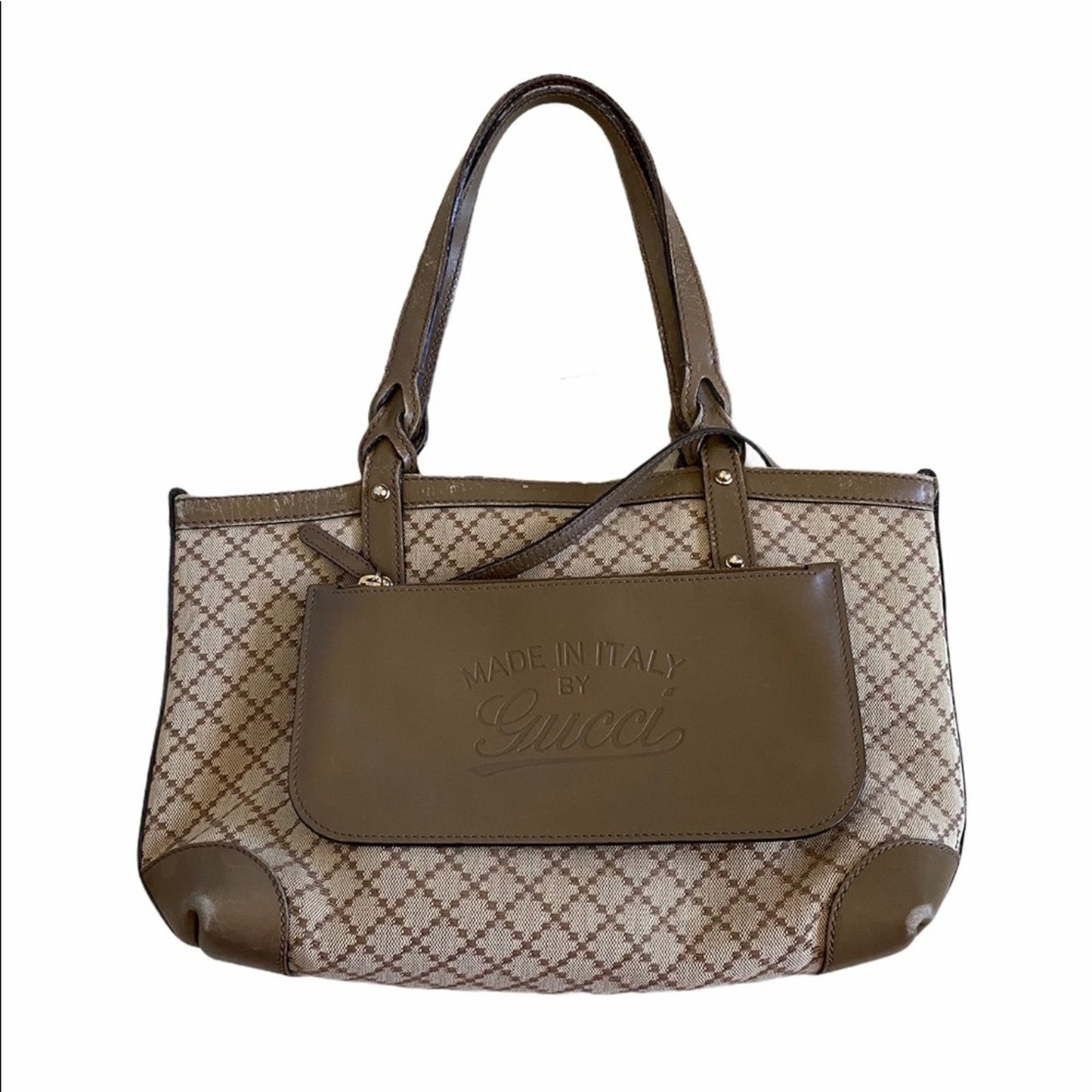 Brown and beige handbag with Gucci logo on a white background